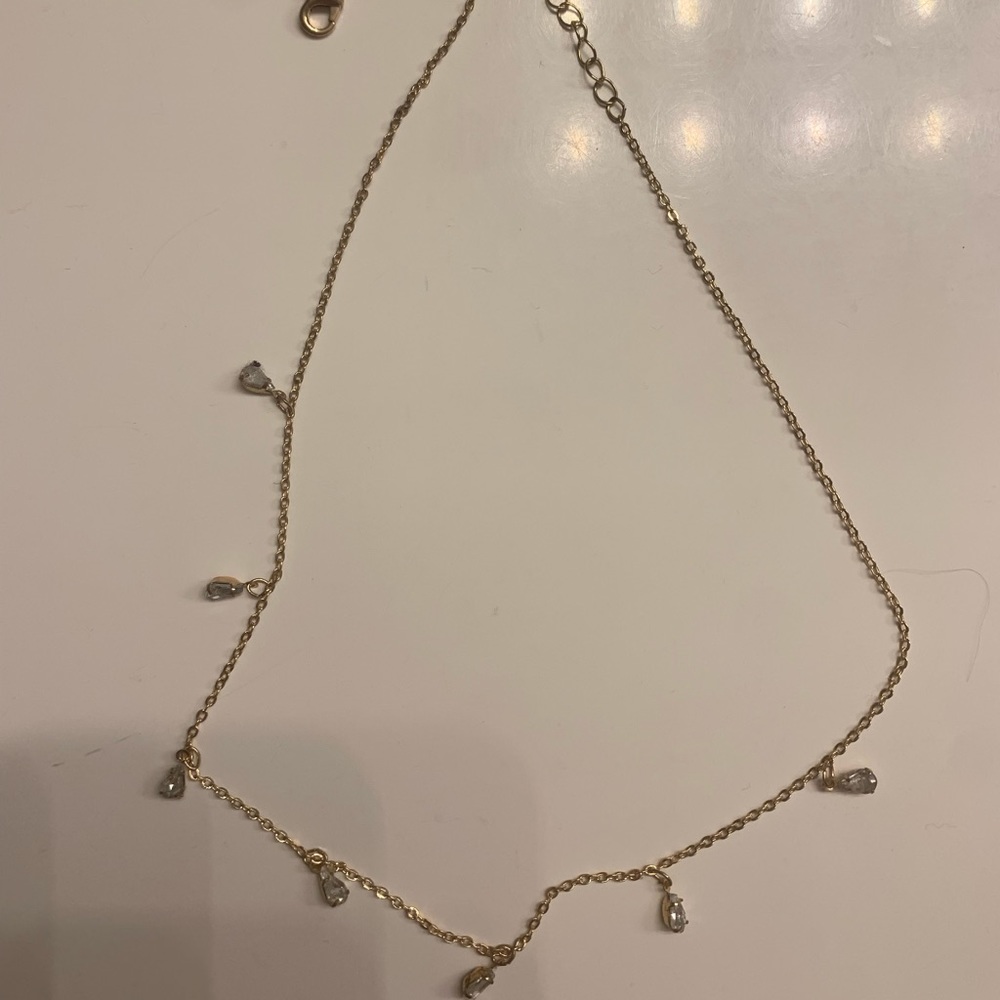 Gold sparkly necklace with mini teardrop shape charms